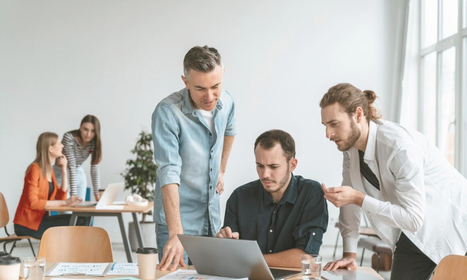 Modern collaborative workspace with entrepreneurs working on startup projects